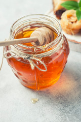 honey in glass jar with dipper