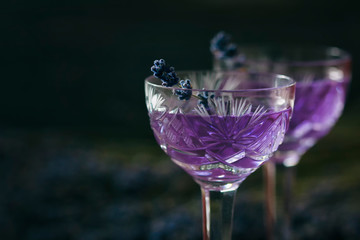 Lavender cocktail on a dark background.