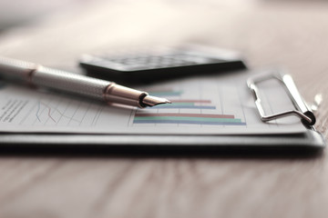 close up. pen with a gold NIB on blurred background office Desk