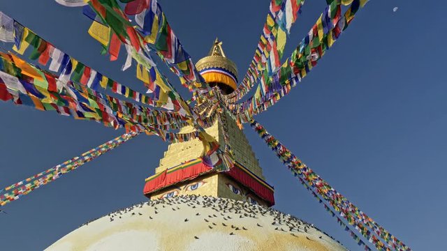 Colorful Buddhist flags and the Boudhanath stupa in Kathmandu, Nepal. 4K, UHD