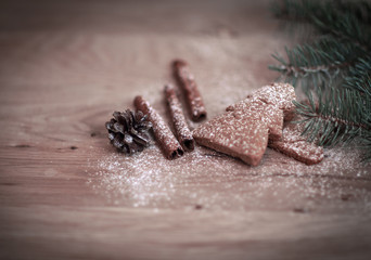 cinnamon sticks, cookies and Christmas tree branch but the tabl