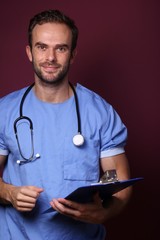 Young doctor in front of a colored background