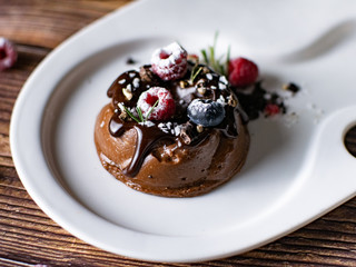 Chocolate cream mousse cake with fresh berries. delicious dessert.