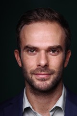 Young man in front of a colored background
