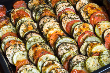 ratatouille vegetarian dish, baked vegetables on a baking tray