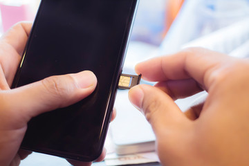 Employees are putting nano SIM cards in the store for customers to buy.