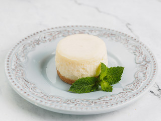 Round classic white mini cheesecake with mint