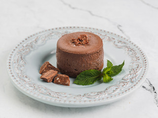Round brown mini cheesecake with chocolate and mint