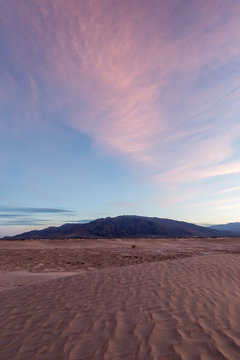Scenic view of Mesquite flat sand dunes against cloudy sky