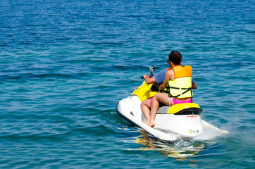 couple of people riding on a jet ski
