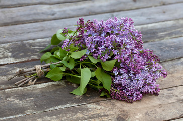 Bouquet of lilac on wood