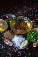 Ingredients for sauce. Selection of spices herbs and greens. Ingredients for cooking. Food  on black background. Angle view.