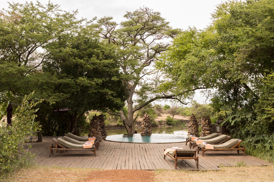 View of lounge chairs besides the infinity pool