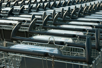 row of shopping carts, outside a large supermarket, in metal and plastic, online, ecommerce, bills, receipt, consumers, italy