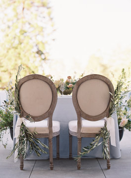 The backs of two chairs at a wedding reception
