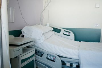 view of a hospital room, electronic bed with clean sheets, ready for patient, hygiene, medicine, doctor, health, Italy