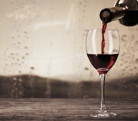 Red wine and glass on background