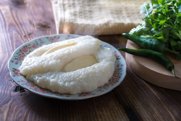 Georgian cuisine - ghomi with cheese on the wooden table