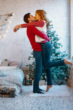 Picture showing young couple hugging and kissing over Christmas