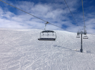 Off-piste ski slope and chair-lift on ski resort