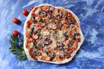 half tasty pizza with mushrooms and cheese on blue