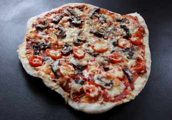 pizza with mushrooms, tomatoes and cheese on black
