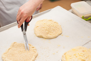 Young children make dough products. Hands closeup
