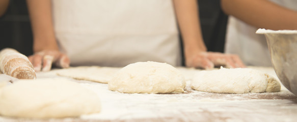 Young children make dough products. Hands closeup