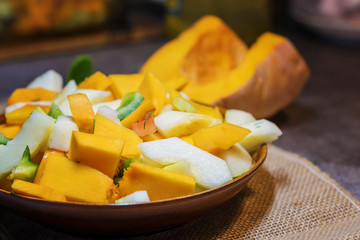 Fresh vegetables (squash, pumpkin, tomatoes, pepper..) cut for cooking. Vegetarian dish.