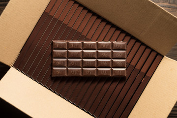 Dark chocolate on a cardboard box. Top view