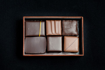 Box Of Chocolate Isolated On Black Background, Top Down View
