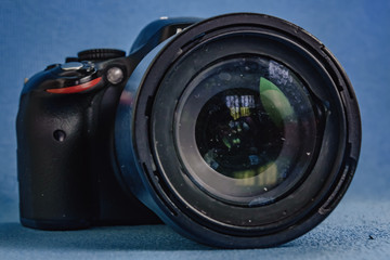 SLR camera on blue background