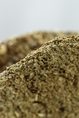 Yerba mate (Ilex paraguariensis) without stems in foreground, vertical close-up