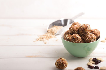 Healthy organic energy granola bolls with nuts, cacao, oats and raisins - vegetarian sweet bites without sugar