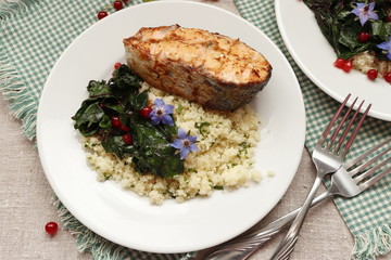 Grilled salmon with couscous and braised chard.