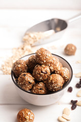 Healthy organic energy granola bolls with nuts, cacao, oats and raisins - vegetarian sweet bites...
