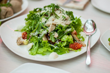 fresh salad on plate with spoon