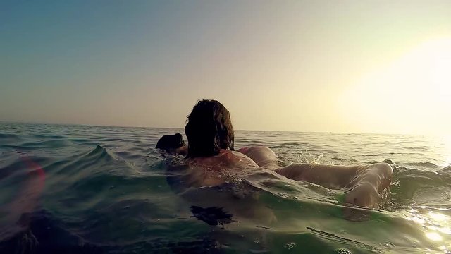Girl rescue sister from drowning at sunset