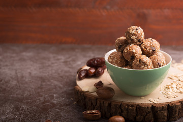 Healthy organic energy granola bolls with nuts, cacao, oats and raisins - vegetarian sweet bites without sugar