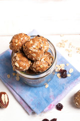 Healthy organic energy granola bolls with nuts, cacao, oats and raisins - vegetarian sweet bites without sugar