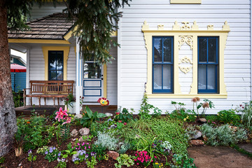 a colorful old house with a garden of flowers