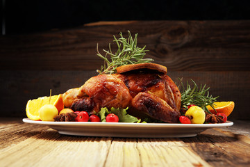 Baked turkey or chicken. The Christmas table is served with a turkey, decorated with fruits, salad...