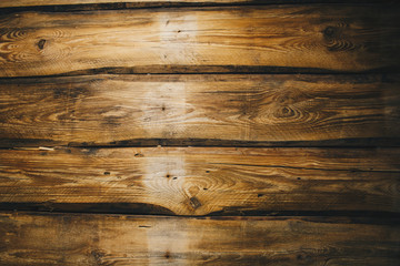 Background of brown old natural wood planks Dark aged empty rural room with tree floor pattern texture Closeup gold view surface of retro pine logs inside vintage light warm interior with shadows
