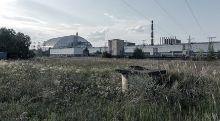 Fototapeta na wymiar Reactor 4 at the Chernobyl nuclear power plant with a new confinement. Global atomic disaster. Chernobyl Exclusion Zone. Pripyat in the area of ​​the sarcophagus over a blasted nuclear reactor