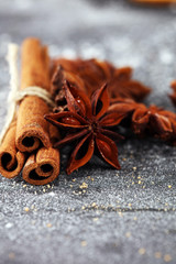 cinnamon and staranise winter spices on rustic background