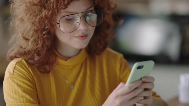 portrait stylish young redhead woman using smartphone taking photo of food blogger in cafe enjoying sharing lifestyle on social media wearing glasses