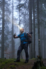 Man with headlamp and backpack in the forest © Xalanx