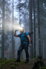 Man with headlamp and backpack in the forest © Xalanx