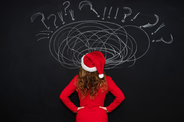 woman with santa claus hat and expression of problems and stress at christmas