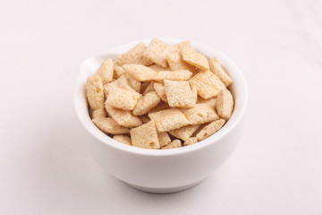 Corn pads in clay bowl on light white background